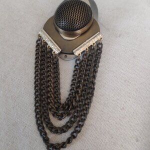 Kiem: Gold tone modernist look brooch with dangling chains.